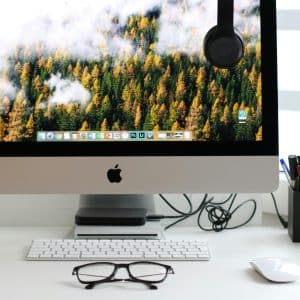 Free Stylish home office workspace featuring a computer setup with accessories. Stock Photo