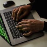 crop-cyber-spy-hacking-system-while-typing-on-laptop