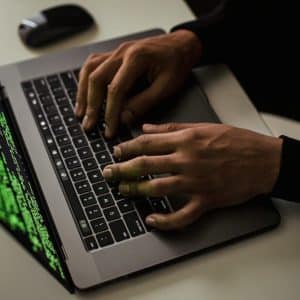 crop-cyber-spy-hacking-system-while-typing-on-laptop