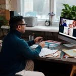 teacher-video-calling-with-his-students-using-a-computer
