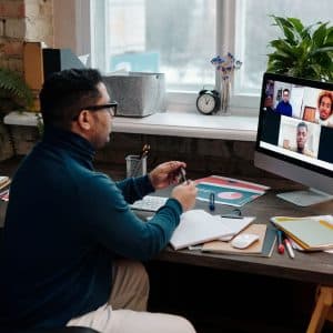 teacher-video-calling-with-his-students-using-a-computer