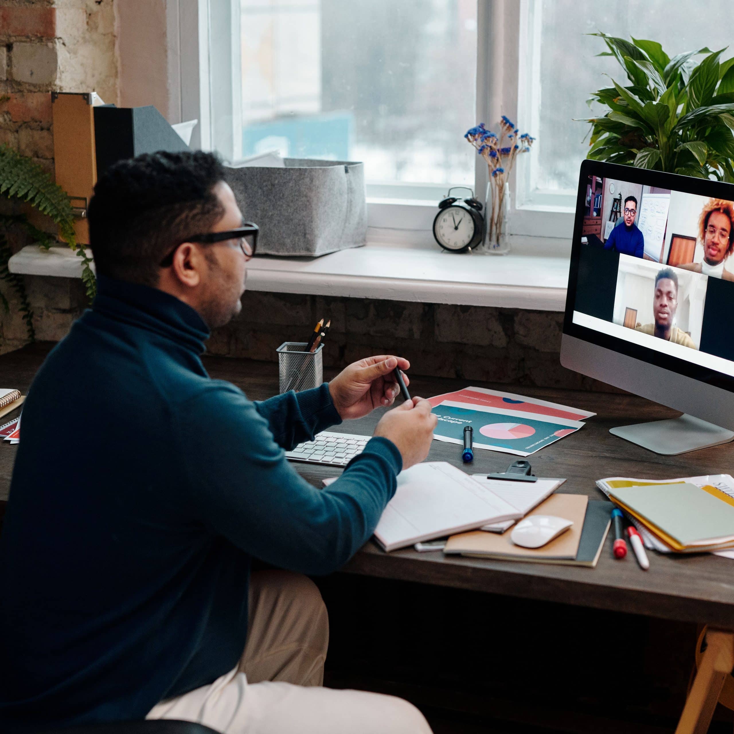 teacher-video-calling-with-his-students-using-a-computer