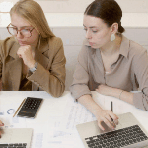 two women with laptops